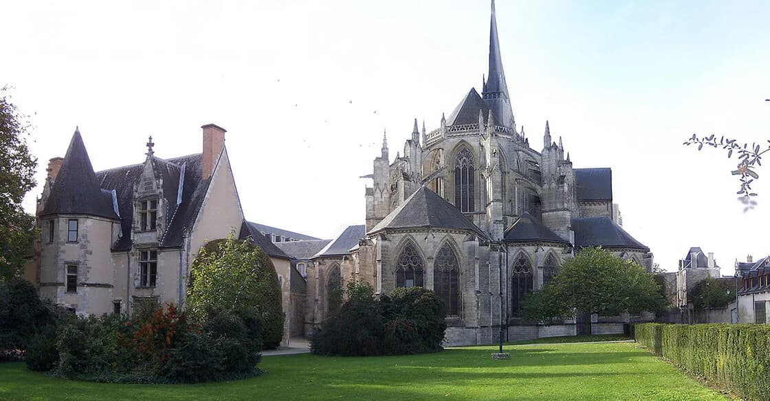 L’abbaye de la Trinité de Vendôme, son chevet gothique et un clocher à flèche, vue depuis une pelouse